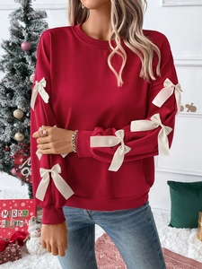 Christmas red crewneck sweatshirt featuring white silk bow details on long sleeves