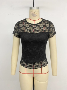 Détail du haut en dentelle noire montrant les motifs floraux et la doublure
