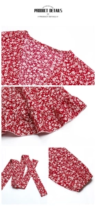 Detail view of red floral fabric with V-neckline, ruffles, and matching tie belt texture