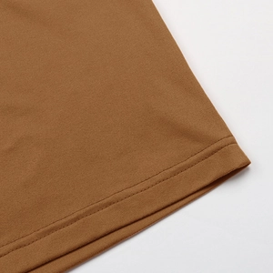 Detail of fine brown knit fabric showing professional double-needle hem stitching finish