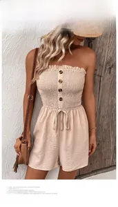 Close-up of smocked tube top jumpsuit with amber buttons and waist drawstring detail