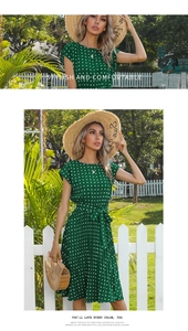 Detail of green polka dot dress with waist belt and sleeveless design in garden setting