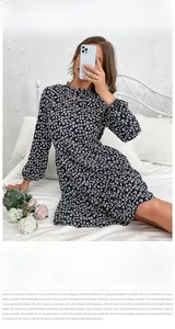 Detail of floral long sleeve dress showing high neckline and elasticated cuffs