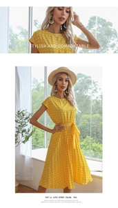 Detail of yellow polka dot summer dress with binding collar and pleated waist design
