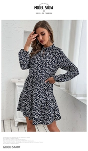 Detail of vintage floral maxi dress showing buttoned collar and dark blue pleated fabric