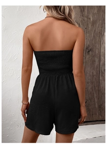 Detailed back view of a black strapless smocked romper with elastic tube top design