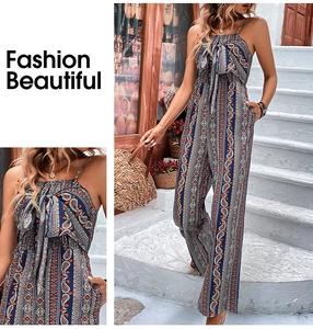 Detail of bohemian paisley print jumpsuit with halter neck and bow tie feature