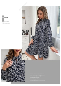 Detail of navy floral long sleeve dress showing high neck cutout and fabric texture