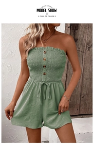 Detail of sage green strapless romper with ruffle neckline and wood-style buttons