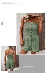 Detail of sage green smocked romper featuring wooden buttons and crinkle fabric texture