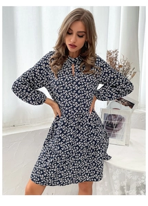 Detailed view of dark blue floral dress featuring a stand collar and teardrop cutout