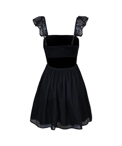 Detail view of backless black mini dress with lace straps and mesh texture fabric