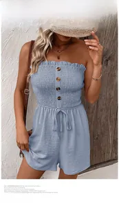 Detail of light blue smocked tube top romper with wood buttons and drawstring waist