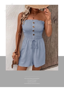 Detail of light blue bandeau romper with ruffled neckline and decorative amber buttons