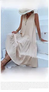 Detail of apricot summer sleeveless maxi dress featuring tiered cake skirt and front buttons