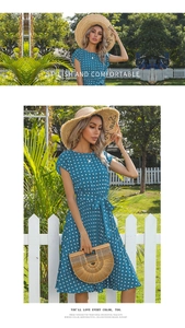 Close-up of summer polka dot dress with pleated skirt and stylish waist belt detail