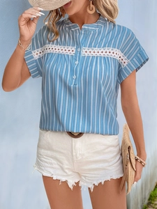 Detail of blue striped short sleeve shirt featuring white lace hollow out embroidery