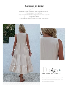 Detail of a beige tiered maxi dress with breathable fabric and layered skirt design