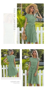 Detail view of green polka dot midi dress with cap sleeves and pleated skirt in outdoor setting