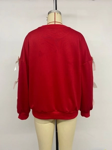 Back view of a red round neck sweatshirt featuring white ribbon bows on long sleeves