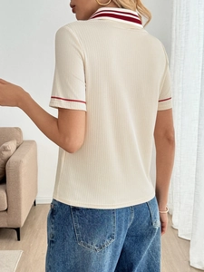 Detail view showing the striped knit texture and back design of a contrast polo shirt