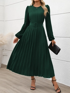 Detail of elegant dark green pleated dress with matching belt and long sleeves