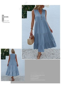 Detail of light blue sleeveless V-neck maxi dress with tiered skirt and button accents