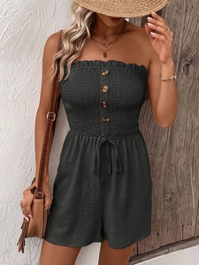 Detail of smocked bandeau romper with amber buttons and waist tie in dark grey