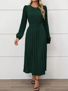 Detailed close-up of dark green midi dress featuring elegant pleated fabric and waist belt