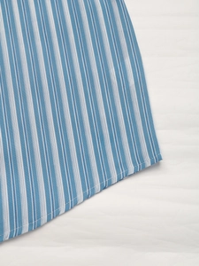 Detail of blue and white vertical striped shirt hem showing fine rolled edge stitching