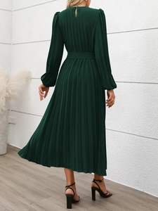 Detail view of the back of a dark green pleated maxi dress featuring a waist belt and buttons