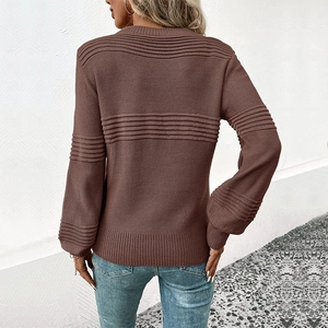 Back view of a brown long-sleeve knit sweater with striped textures and blue jeans