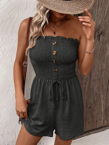 Detail of shirred tube top romper with wood-textured buttons and drawstring waist