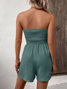 Detail view of the smocked back design on a strapless summer romper in teal blue