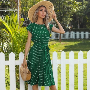 Green summer pleated dress with white polka dots, short sleeves and waist tie detail