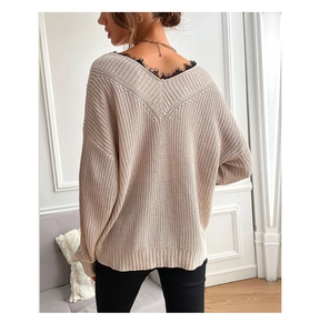 Close-up of beige V-neck knit sweater featuring delicate black lace trim at the neckline