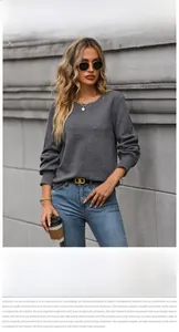 Detailed view of dark grey sweatshirt with unique geometric square textured knit pattern