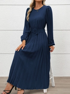 Detail of navy blue pleated dress featuring textured fabric and matching waist belt