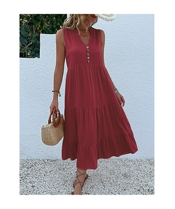 Detail of red V-neck sleeveless dress with buttons and three-tier pleated skirt design