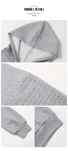 Detail of grey textured hoodie showing quilted waffle fabric and ribbed cuffs and hem
