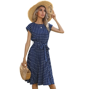 Navy blue polka dot midi dress with short sleeves, waist belt and pleated skirt style