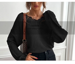 Detail view of V-neck knitted sweater with fringe edges and ribbed texture for women
