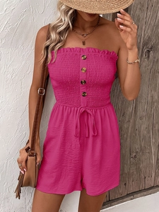 Close-up of rose pink tube top romper featuring wooden buttons and drawstring waist