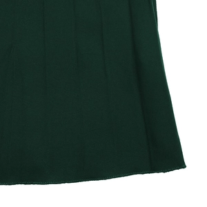 Macro detail of dark green pleated skirt hem with fine stitching and smooth fabric