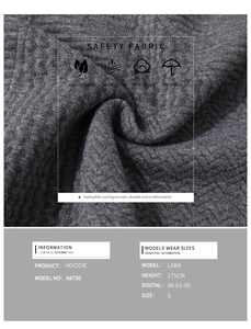 Detail of dark grey textured hoodie showing herringbone weave fabric and model info