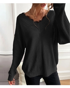 Detail of V-neckline with delicate black lace trim on a ribbed knit sweater for women