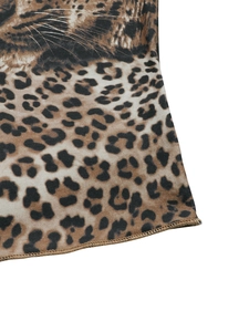 Dettaglio del tessuto leopardato con cuciture overlock e stampa viso di felino