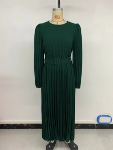 Detail of dark green long sleeve pleated dress with waist belt and elegant round neck