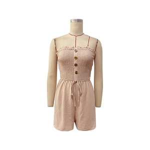 Close-up of smocked tube romper with amber buttons and drawstring waist detail