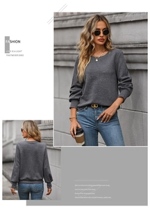 Detailed view of dark grey long sleeve sweater with geometric textured embossing pattern